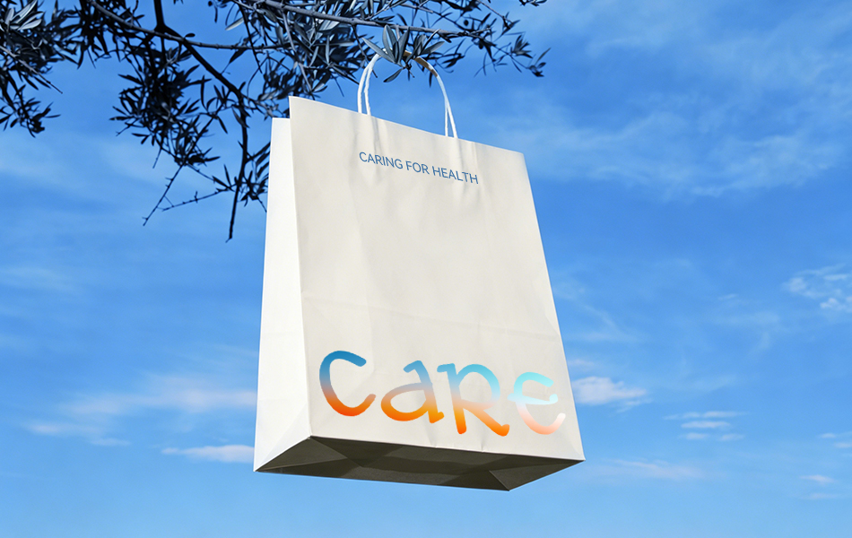 宏洛图设计 CARE 品牌手提纸袋视觉,米白特种牛皮纸搭配渐变彩虹手写 CARE 烫印工艺,户外树枝悬挂实景传递天然健康轻养护品牌调性